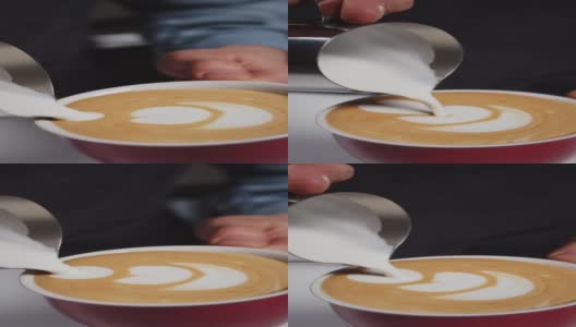 咖啡师制作的咖啡拿铁艺术与美丽的形状纹理。垂直视频的智能手机和网络的目的，咖啡师的手倒牛奶到咖啡杯与卡布奇诺。慢动作高清在线视频素材下载