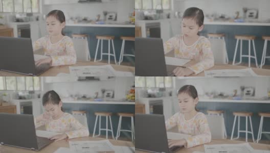 混合亚洲女孩在家里用笔记本电脑视频通话，使用缩放在线虚拟课堂，社交距离，在家上学，远程学习，新常态概念高清在线视频素材下载