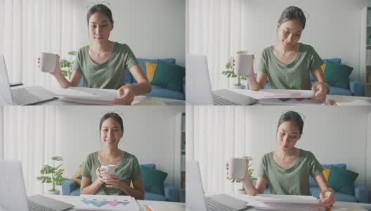 亚洲商务女性，穿着休闲服装，在家中客厅用笔记本电脑工作，喝咖啡。高清在线视频素材下载