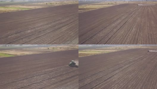 绿色拖拉机从上到下鸟瞰图的耕地和播种干燥的田野。农民在早春季节用苗床耕田作为播种前活动的一部分。高清在线视频素材下载