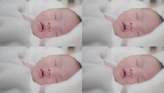 可爱的可爱的小新生儿的肖像脸婴儿在家里睡觉，幸福的新生儿在舒适的家在白天照明室内高清在线视频素材下载