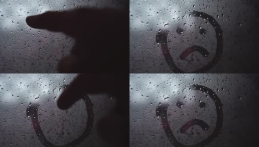 在磨砂雾蒙蒙的玻璃上手写着一个悲伤的微笑。高清在线视频素材下载