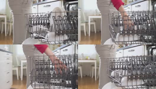 年轻女子从洗碗机里拿出干净的盘子高清在线视频素材下载