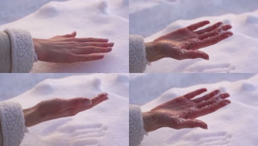 在阳光明媚的冬日里，一个陌生女人的手掌在雪堆上留下了手印。高清在线视频素材下载
