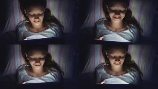 女孩躺在床上用平板电脑看视频高清在线视频素材下载