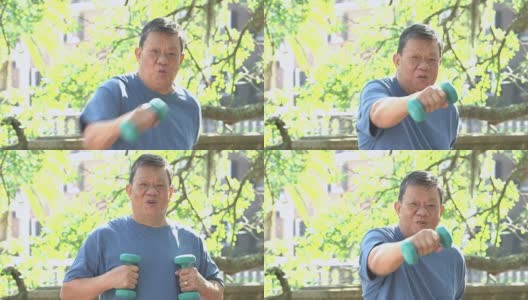 年长的亚洲男子在公园里练哑铃高清在线视频素材下载