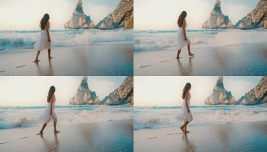 宽阔的年轻女子在普拉亚达熊萨海滩在葡萄牙高清在线视频素材下载