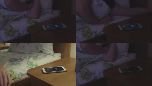 一名女子在床上睡觉，手机屏幕上显示着闹钟高清在线视频素材下载