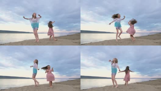 两个孩子在海滩上尽情跳舞。高清在线视频素材下载