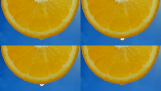 橙汁从一片橘子上滴下的一滴纯净水或果汁高清在线视频素材下载