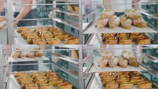 面包师在面包房的钢架上放置新鲜的法式长棍高清在线视频素材下载