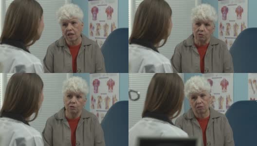 女医生和老病人谈话。高清在线视频素材下载