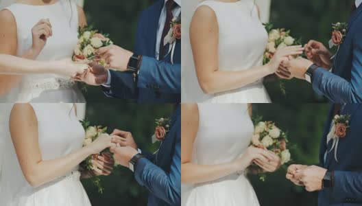 在绿草如茵的背景下，新婚夫妇交换戒指。高清在线视频素材下载
