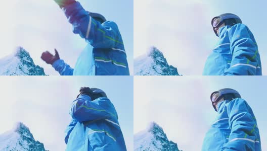 低角度的女性滑雪者把她的眼镜在蓝色的天空高清在线视频素材下载