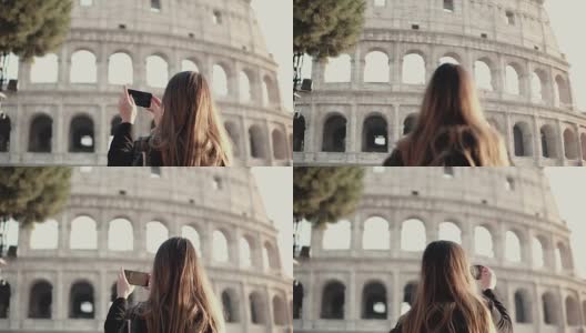 年轻的黑发游客探索罗马斗兽场，意大利。女人用智能手机拍照高清在线视频素材下载