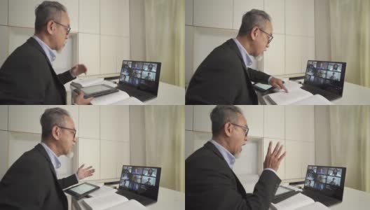 亚洲华人资深男教授家教老师给他的成年学生使用笔记本电脑在家里工作高清在线视频素材下载