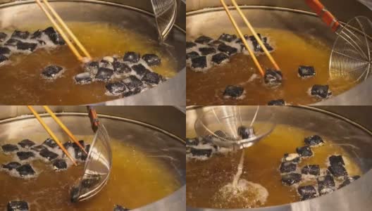 把臭豆腐放在锅里用油炸，这是中国的传统小吃高清在线视频素材下载