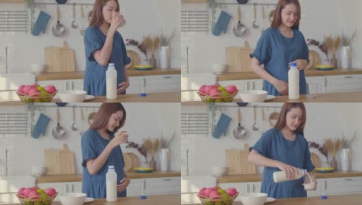 一位孕妇正在喝牛奶，轻轻地摸着她的肚子，怀孕/分娩高清在线视频素材下载