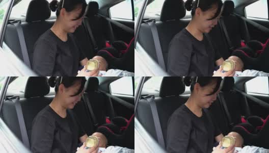 母亲在车里给婴儿喂奶高清在线视频素材下载