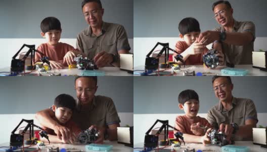 父亲和儿子在家里制作机器人玩具高清在线视频素材下载