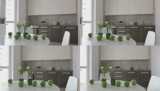 4 k。斯堪的纳维亚风格的现代厨房内部。移动全景与苹果和鲜花高清在线视频素材下载