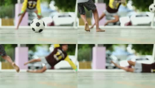 在泰国的一个村庄里，农村的孩子们正在踢足球，慢镜头，散焦高清在线视频素材下载