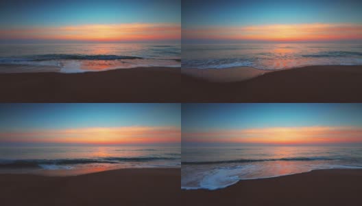 海面和海滩上的日出。海浪冲刷着沙滩高清在线视频素材下载