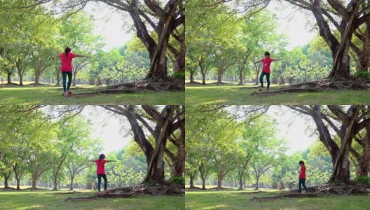 一个年轻女孩在公园的树下散步高清在线视频素材下载