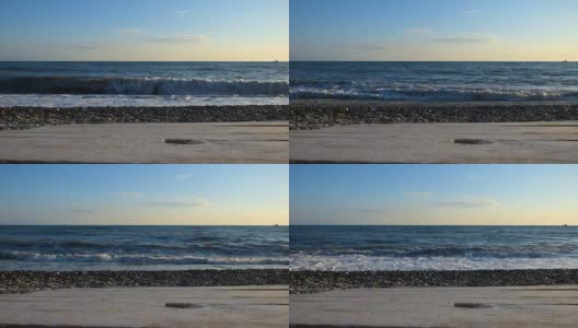 海边的沙滩用石头和卵石模糊了前面的木质平台表面。高清在线视频素材下载