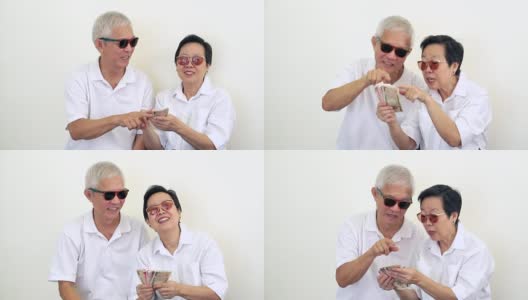 幸福富有的亚洲老年夫妇的视频。中彩票或赌场的现金高清在线视频素材下载