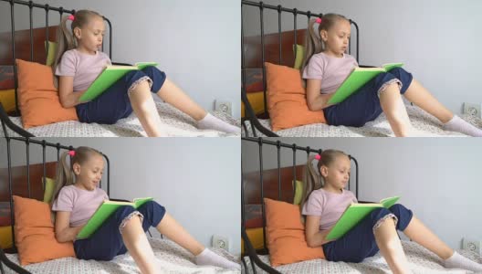 女孩在家里慢慢地、清晰地读着一本书高清在线视频素材下载