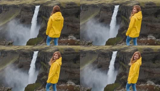 一个女人站在悬崖上，俯视着瀑布高清在线视频素材下载