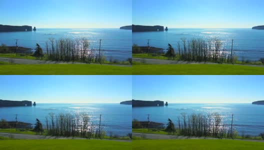著名的Rocher Perce岩石在加斯皮半岛，魁北克，加拿大，加斯皮西地区在蓝色日出和波光粼粼的阳光路径博纳旺蒂尔岛高清在线视频素材下载