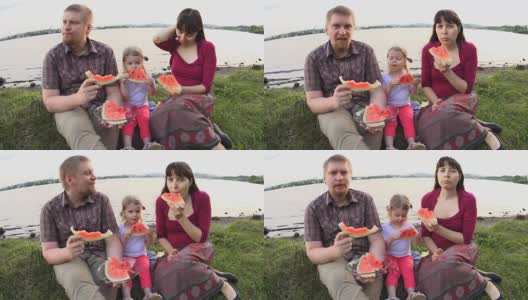 在一个夏日，一家人在池塘边野餐，一起吃西瓜高清在线视频素材下载