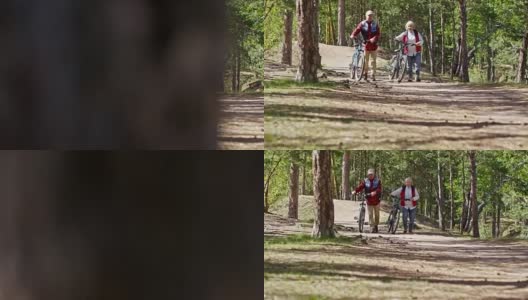 在森林里骑自行车散步的退休老人高清在线视频素材下载