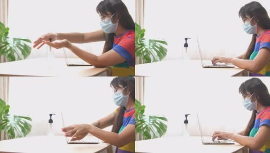 亚洲商务女性带口罩工作与电脑和使用杀菌剂凝胶在家办公，商务人士由于病毒危机在家工作高清在线视频素材下载