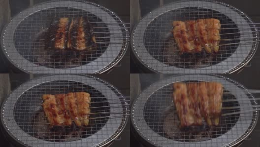 在日本，人们习惯在炎热的夏天吃鳗鱼，并拍下鳗鱼在木炭上烧烤的照片。高清在线视频素材下载