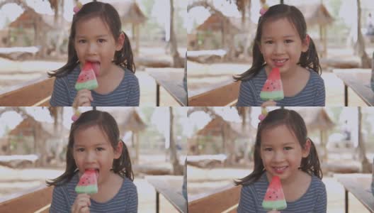手持慢动作年轻混合亚洲女孩吃西瓜冰棒在炎热的夏天假期高清在线视频素材下载