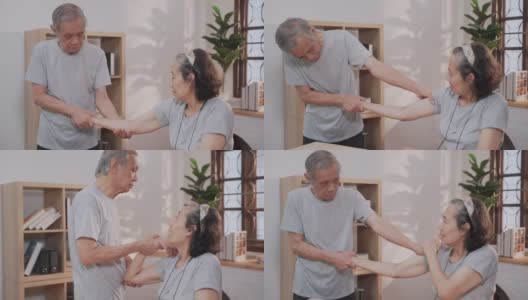 老年男医护人员在家伸展老年女病人的手臂高清在线视频素材下载