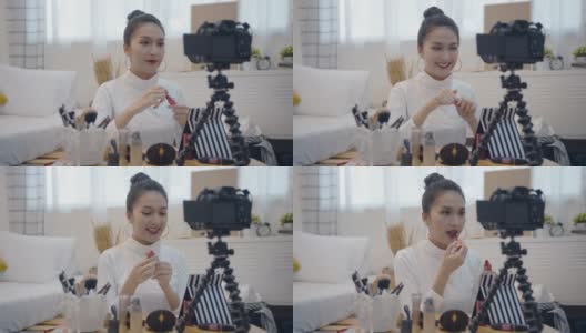 年轻的亚洲女性美网博主录制视频与化妆品高清在线视频素材下载