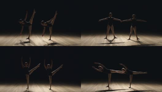 2、两个芭蕾舞演员在黑暗的舞台上跳舞，慢墨高清在线视频素材下载