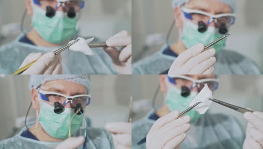特写镜头中，外科医生手里拿着一个夹着手术针的夹子，背景中是一位戴着眼镜的医生。医院无菌医疗器械。手术前医疗设备的准备。健康的概念，设备在高清在线视频素材下载
