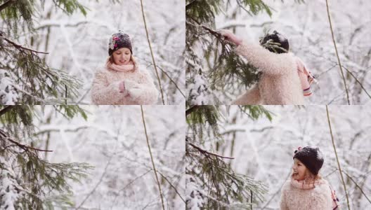 快乐的女孩在森林里摇着树枝上的雪。快乐的童年。冬天的乐趣高清在线视频素材下载