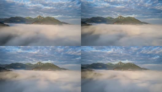 史诗般的飞翔在清晨群山的云层上时光流逝高清在线视频素材下载