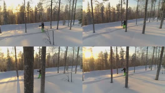 在金色的冬日夕阳下，女孩穿着雪鞋在厚厚的雪地上徒步行走高清在线视频素材下载