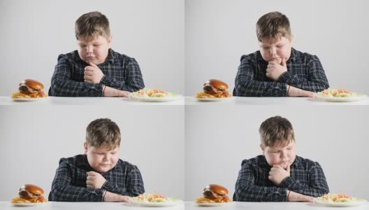 年轻的胖男孩选择健康和不健康的食物50帧/秒高清在线视频素材下载