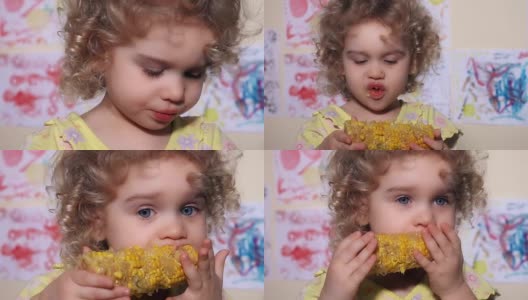 小女孩咬了一口玉米棒子高清在线视频素材下载