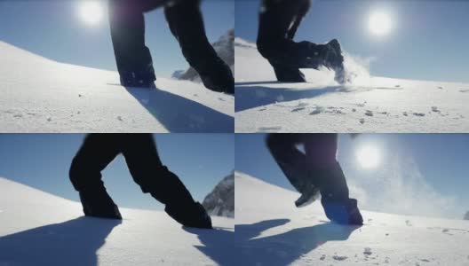 慢镜头拍摄的人走在雪山环境在阳光明媚的一天高清在线视频素材下载