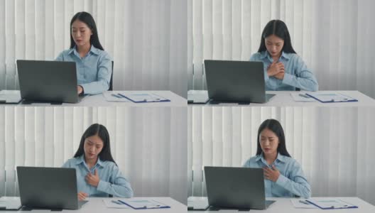 一名亚洲妇女在工作时感到胸部疼痛。高清在线视频素材下载