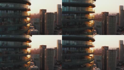 吊起Arena Tower公寓楼周围阳台的画面。由夕阳背光。英国伦敦高清在线视频素材下载